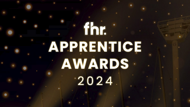 Apprentice receiving award on stage at 2024 event