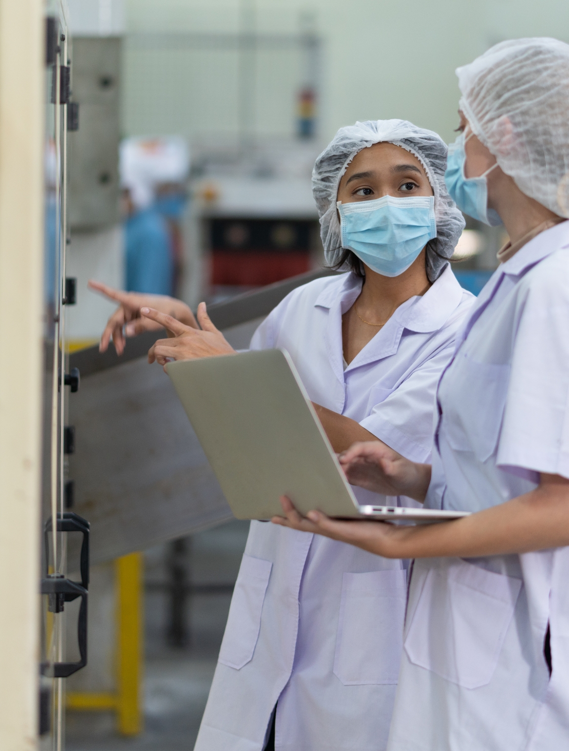 Two female Pharmaceutical line workers