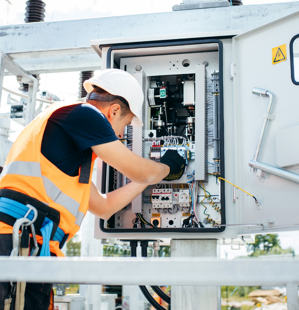 Electrical engineer repairing switchboard