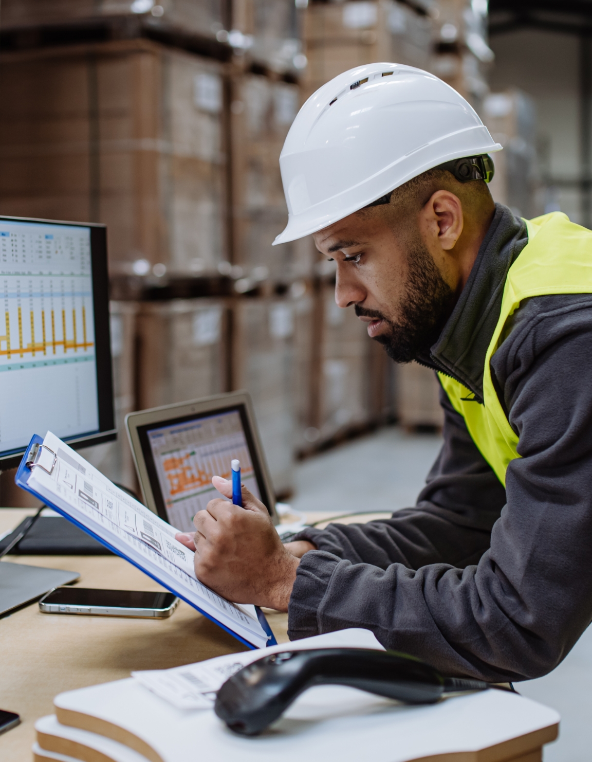 Warehouse manager reviewing clipboard