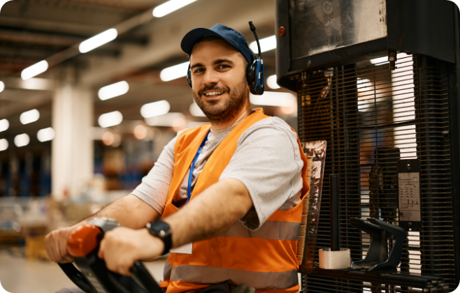 Man in high vis driving forklift